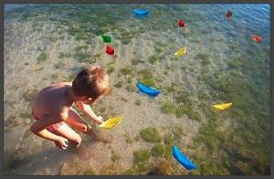 kid-playing-with-paper-boats