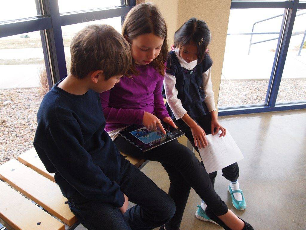 Kids with iPad learning Math