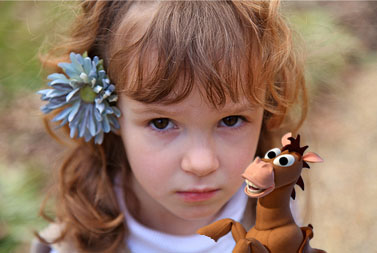 Cute Girl with Horse Toy