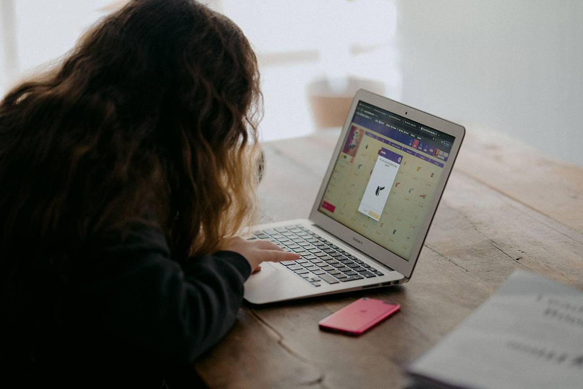 Teenage girl using laptop computer