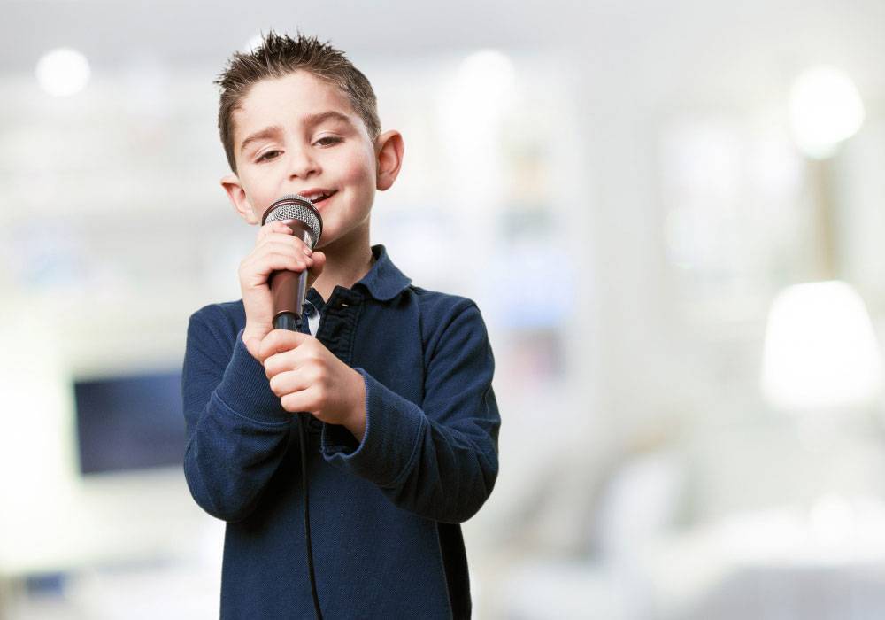 Boy child with microphone - public speaking