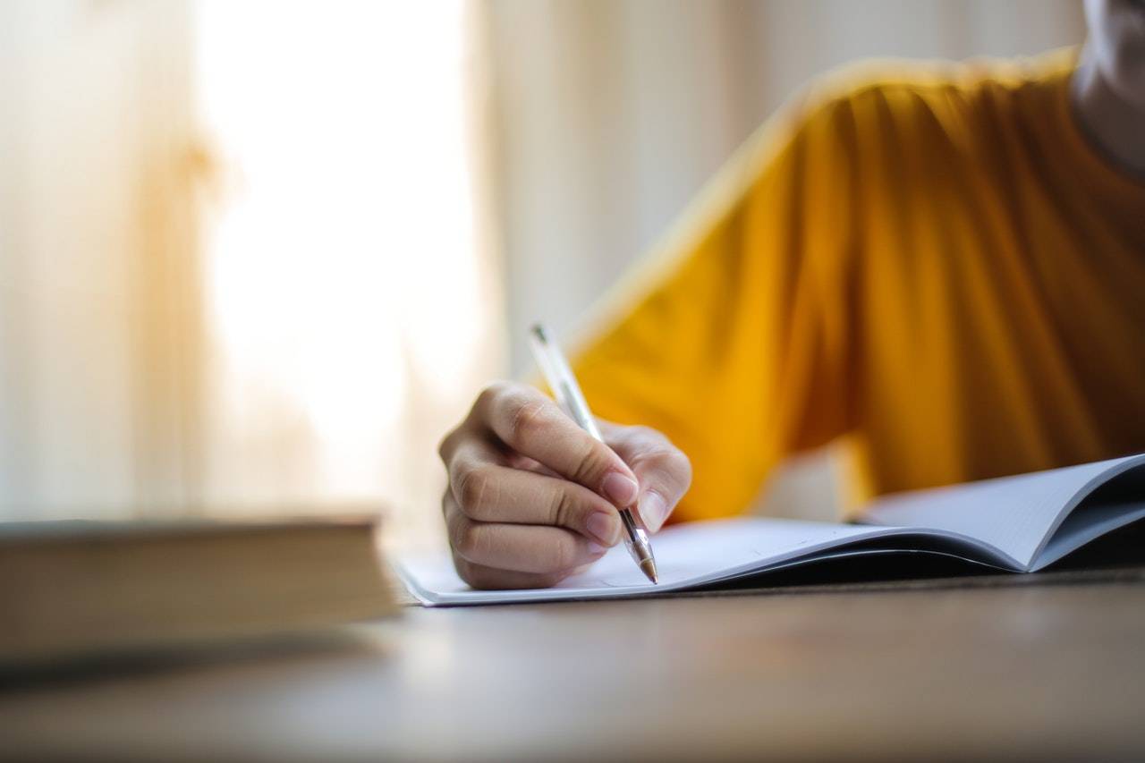 Child writing on a Book