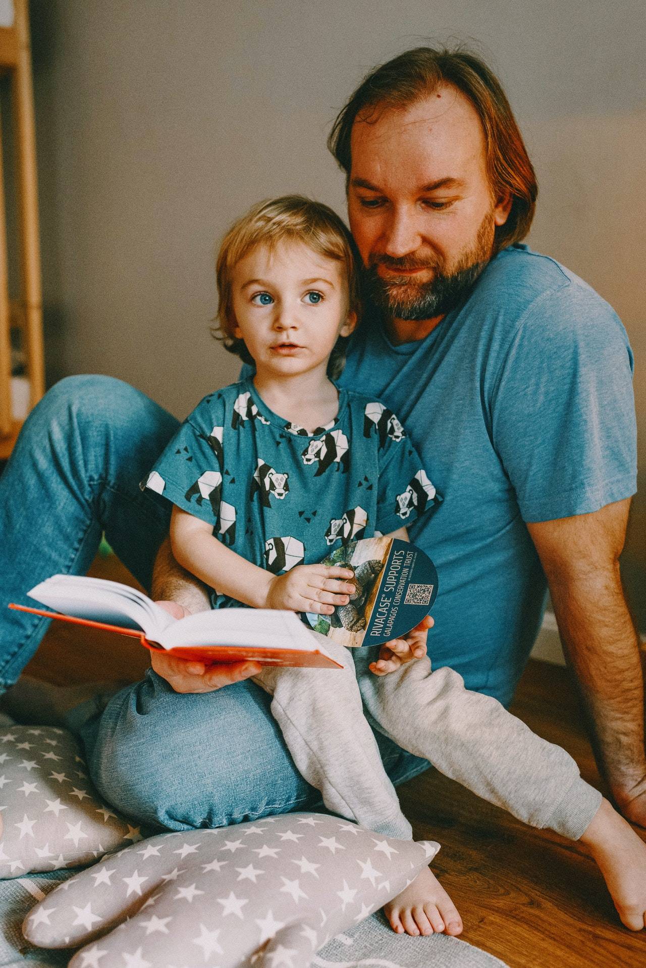 Father Reading Book to Daughter