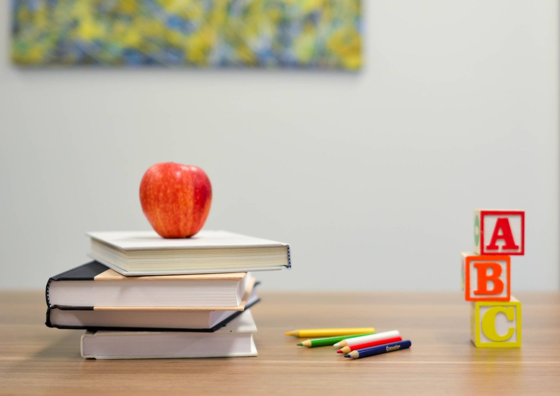Red apple fruit on four books