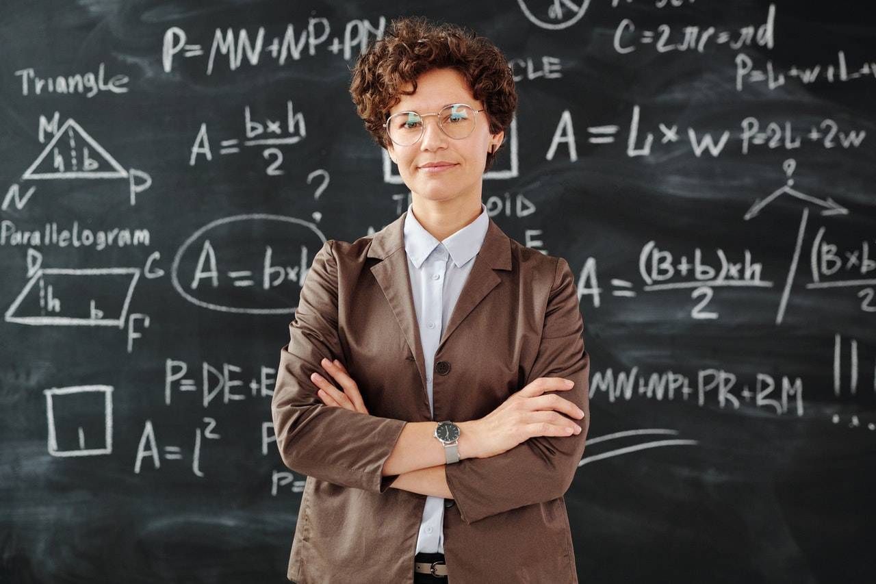 Math Teacher Standing in front of the Blackboard
