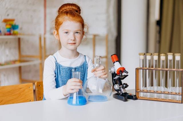 A Girl Holding Flasks