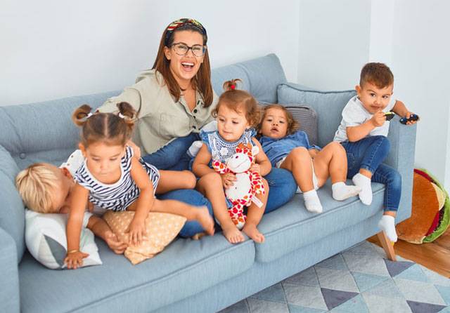 Beautiful teacher and group of toddlers