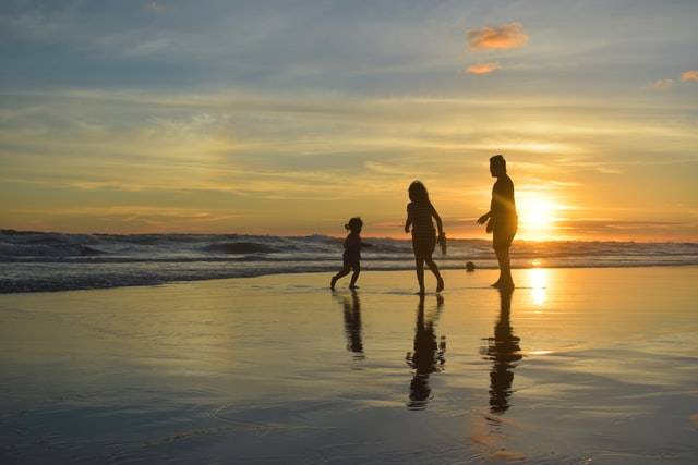 Parents with Child Playing in the Beach