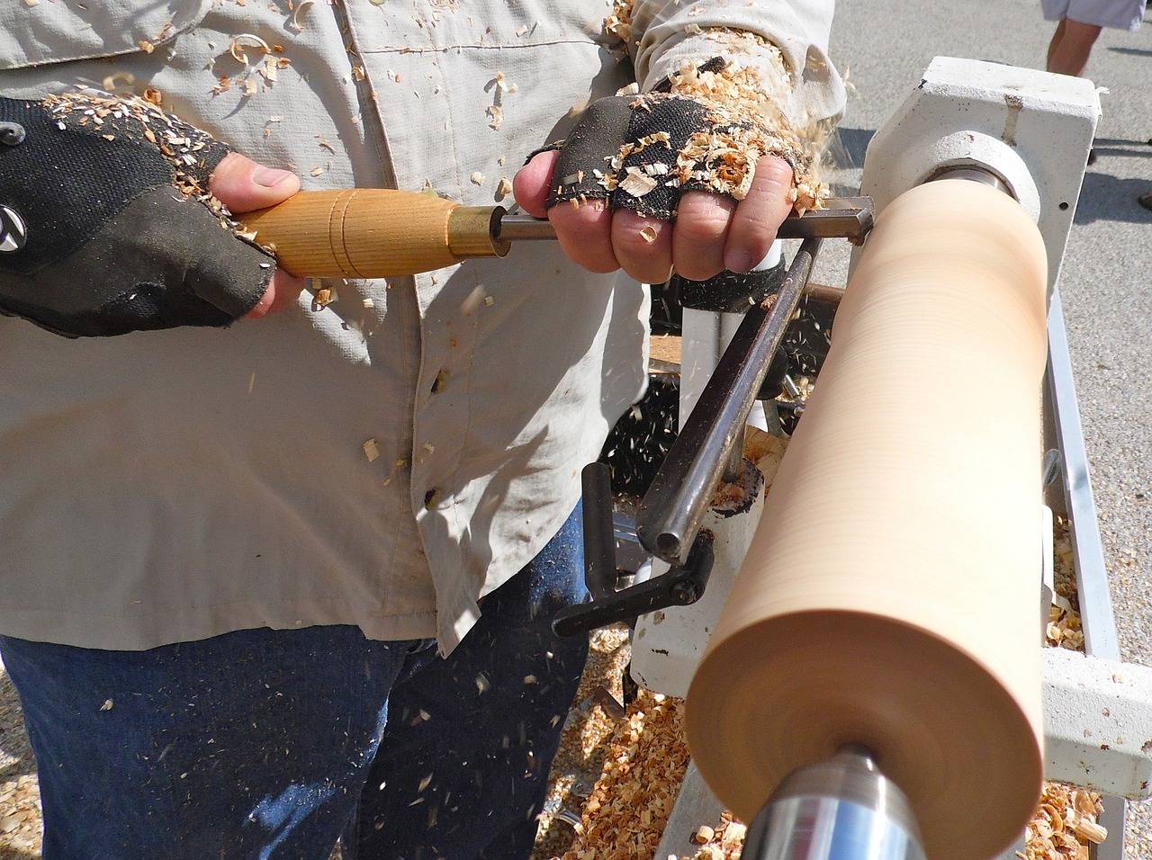 artisan covered in wood shavings