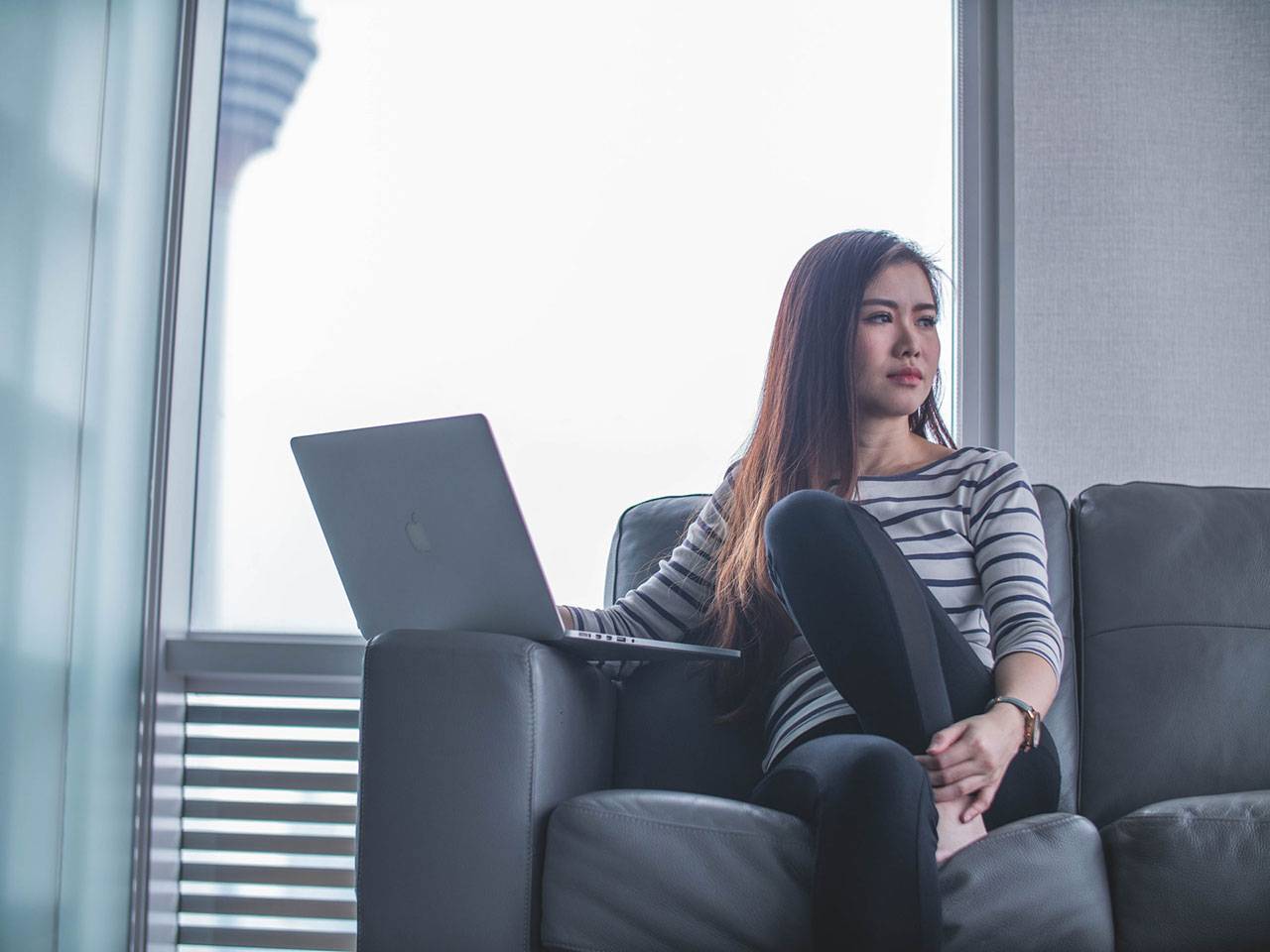 Lady with Laptop sitting on sofa