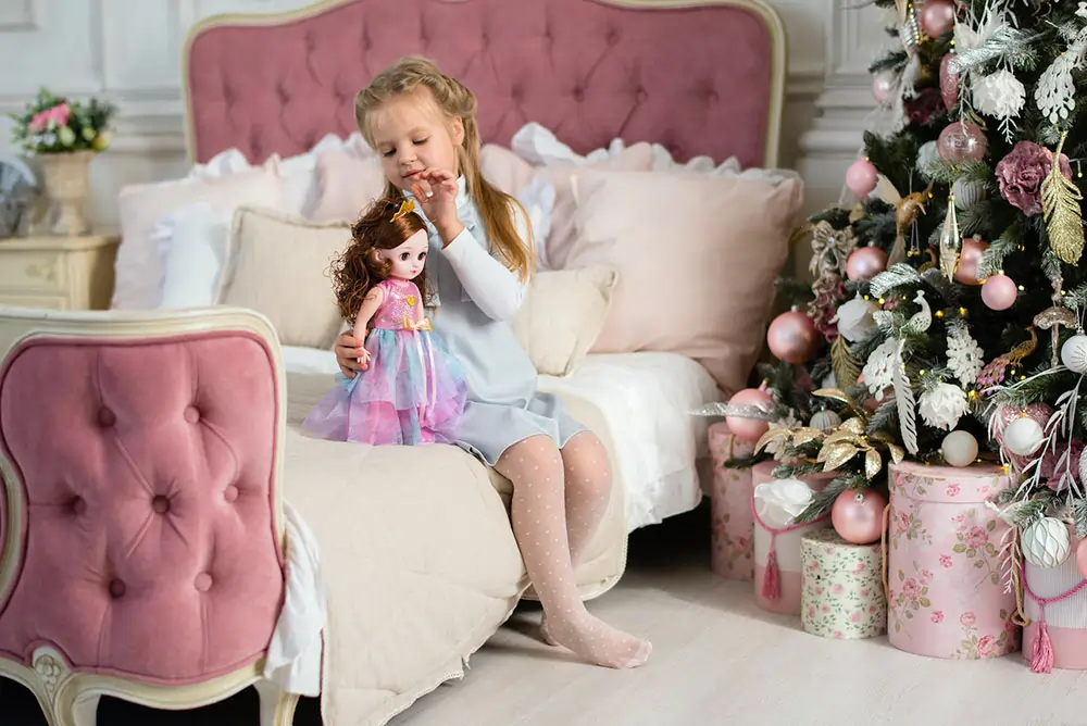 Girl dressing doll