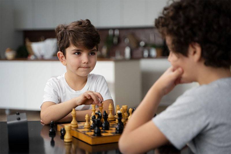 Kids Playing Chess – Learning Strategy and Focus